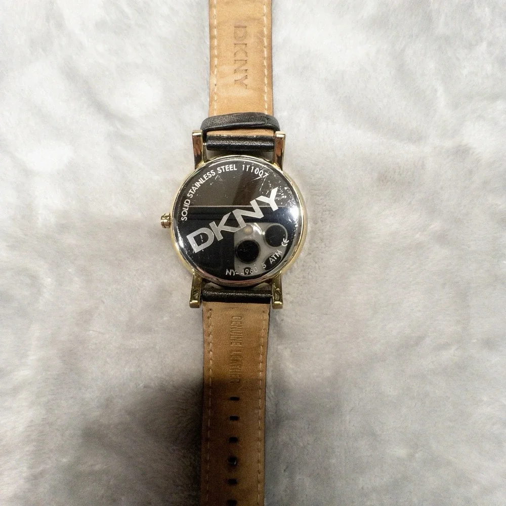 DKNY 111007 Gold Tone All Over Logo Womens 43mm Wristwatch Gem Set Bezel
